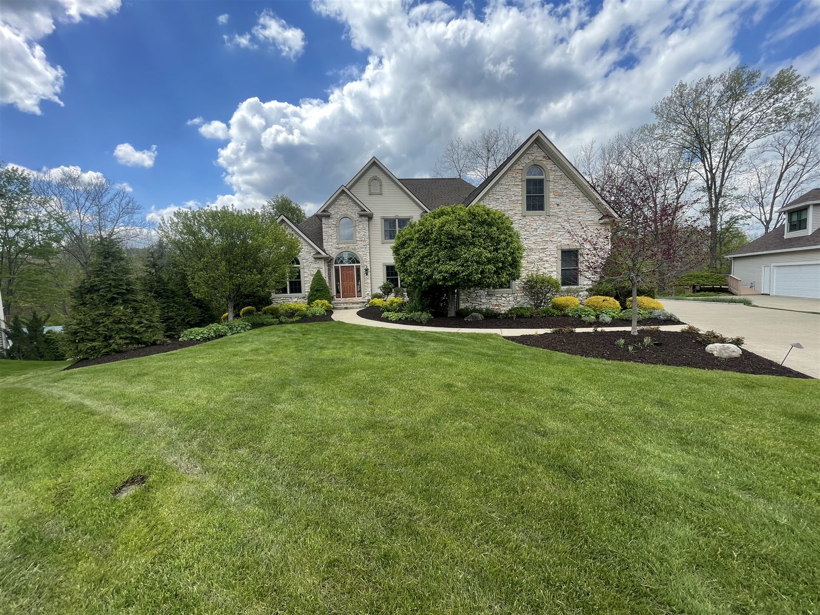 Manicured lawn and landscaping at a large home
