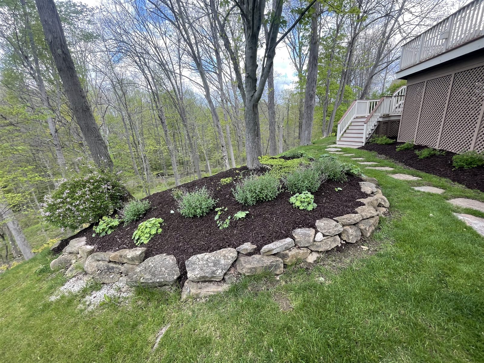 Natural stone retaining wall with landscaping